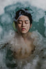 Man's face showing through bath water. Photo by Hisu lee on Unsplash